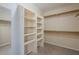 Organized walk-in closet features built-in shelving and ample storage space at 10722 W Irma Ln, Peoria, AZ 85373