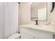 Bright bathroom featuring a white vanity with modern fixtures and a shower with a stylish patterned curtain at 11531 E Persimmon Ave, Mesa, AZ 85212
