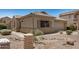 The exterior is landscaped with desert rock and desert foliage at 11531 E Persimmon Ave, Mesa, AZ 85212