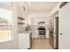 Modern kitchen features stainless steel appliances, white cabinets, and tile flooring at 11531 E Persimmon Ave, Mesa, AZ 85212