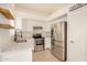 Modern kitchen features stainless steel appliances and bright white cabinets at 11531 E Persimmon Ave, Mesa, AZ 85212