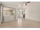 Bright living room with tile flooring, big windows, and a ceiling fan at 11531 E Persimmon Ave, Mesa, AZ 85212