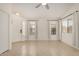 Bright living room with neutral tile flooring, lots of light, and a ceiling fan at 11531 E Persimmon Ave, Mesa, AZ 85212