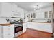 Updated kitchen with stainless steel appliances, white cabinets and gas range at 1233 E El Camino Dr, Phoenix, AZ 85020