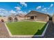 Backyard with a pool, lawn area, and low maintenance landscaping at 12712 W Milton Dr, Peoria, AZ 85383