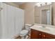 Small bathroom featuring a toilet, shower and sink with dark wood vanity at 12712 W Milton Dr, Peoria, AZ 85383
