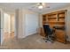 Bedroom features built-in desk and storage, ceiling fan, and sliding closet doors at 12712 W Milton Dr, Peoria, AZ 85383