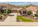 Beautifully landscaped home with stone accents, a spacious driveway, and a well-maintained lawn at 12712 W Milton Dr, Peoria, AZ 85383