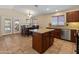 Eat-in kitchen boasts granite countertops, a center island, and backyard access at 12712 W Milton Dr, Peoria, AZ 85383