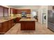 Bright kitchen featuring stainless appliances and an island with granite countertops at 12712 W Milton Dr, Peoria, AZ 85383