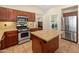 Well-equipped kitchen with granite counters, stainless appliances and center island at 12712 W Milton Dr, Peoria, AZ 85383