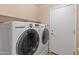 Laundry room with a washer and dryer and shelving for storage at 12712 W Milton Dr, Peoria, AZ 85383
