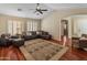 Cozy living room with wood floors, plush seating, plantation shutters, and an open layout at 12712 W Milton Dr, Peoria, AZ 85383