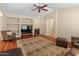 Comfortable living room features a fireplace, built-in shelving and hardwood floors at 12712 W Milton Dr, Peoria, AZ 85383