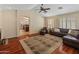Comfortable living room featuring wood floors, natural light, and an open layout for entertaining guests at 12712 W Milton Dr, Peoria, AZ 85383