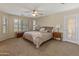 Spacious main bedroom with large windows, a ceiling fan, and private patio access at 12712 W Milton Dr, Peoria, AZ 85383