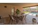 Covered patio area with dining table and chairs, perfect for outdoor relaxation and entertainment at 12712 W Milton Dr, Peoria, AZ 85383