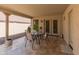 Comfortable covered patio area with table, chairs, and sliding glass doors at 12712 W Milton Dr, Peoria, AZ 85383