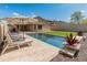 Inviting backyard pool with lounge chairs and desert plants, great for entertaining at 12712 W Milton Dr, Peoria, AZ 85383
