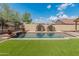 Stunning backyard pool with desert landscaping and in-pool lounge chairs at 12712 W Milton Dr, Peoria, AZ 85383