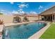 Sparkling backyard pool with water feature, tanning ledge, and lounge chairs at 12712 W Milton Dr, Peoria, AZ 85383
