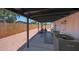 Covered patio with string lights, workout area, air conditioner unit, and fenced backyard at 12810 N 20Th St, Phoenix, AZ 85022