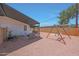Large gravel backyard with a covered patio, playset and side yard, perfect for Gathering activities at 12810 N 20Th St, Phoenix, AZ 85022