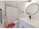 Bright bathroom featuring white vanity, modern fixtures, floral shower curtain, and neutral-toned walls at 12810 N 20Th St, Phoenix, AZ 85022