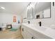 Luxurious bathroom featuring a standalone tub, double sinks, modern fixtures, and wood-look flooring at 12810 N 20Th St, Phoenix, AZ 85022