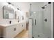 Stylish bathroom featuring a double sink vanity, a glass-enclosed shower, and modern fixtures at 12810 N 20Th St, Phoenix, AZ 85022