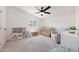 Bright bedroom with a crib, toys, ceiling fan, and neutral carpet at 12810 N 20Th St, Phoenix, AZ 85022