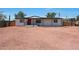 Charming single-story home features a red front door, metal overhang, and a gravel front yard for low maintenance appeal at 12810 N 20Th St, Phoenix, AZ 85022