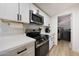 Well-equipped kitchen boasts stainless steel appliances, white countertops, and convenient access to the laundry area at 12810 N 20Th St, Phoenix, AZ 85022