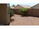 Private backyard includes a wall, desert landscaping, and mature shrubs at 13861 W Elm St, Surprise, AZ 85374