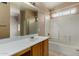 Bright bathroom featuring a shower-tub combo, vanity, and neutral tones at 13861 W Elm St, Surprise, AZ 85374