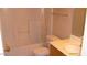 A clean bathroom with a shower-tub combo, single sink vanity, and bright lighting, offering comfort and functionality at 13861 W Elm St, Surprise, AZ 85374