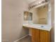 Bathroom vanity with a large mirror and light fixture at 13861 W Elm St, Surprise, AZ 85374