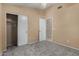 Bedroom with closet and doorway, featuring neutral walls and carpet at 13861 W Elm St, Surprise, AZ 85374