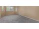 Neutral bedroom with neutral carpet, a bright window, and natural light at 13861 W Elm St, Surprise, AZ 85374