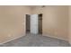 Bedroom featuring open doorway and closet with neutral walls and carpet at 13861 W Elm St, Surprise, AZ 85374