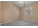 Cozy bedroom with a ceiling fan, window, and neutral carpet at 13861 W Elm St, Surprise, AZ 85374