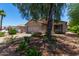 Inviting single-story home with a two-car garage and lush desert landscaping at 13861 W Elm St, Surprise, AZ 85374