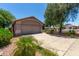 Lovely single-story home with a large driveway and mature desert landscaping at 13861 W Elm St, Surprise, AZ 85374