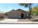 Charming single-story home featuring a well-maintained front yard and attached two-car garage at 13861 W Elm St, Surprise, AZ 85374