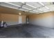 Spacious two car garage featuring concrete floors and an attached water heater at 13861 W Elm St, Surprise, AZ 85374