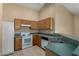Cozy kitchen featuring neutral-colored cabinets and appliances at 13861 W Elm St, Surprise, AZ 85374