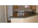 Functional kitchen with ample counter space, white appliances, and wood cabinetry, offering convenience and storage at 13861 W Elm St, Surprise, AZ 85374