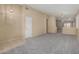 Open living space featuring neutral carpet, tile flooring, and bright natural light at 13861 W Elm St, Surprise, AZ 85374