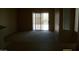 A neutral living room with a sliding glass door to the exterior with plush carpeting at 13861 W Elm St, Surprise, AZ 85374