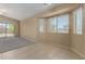 Versatile living room featuring tile flooring, plush carpet, and ample natural light at 13861 W Elm St, Surprise, AZ 85374